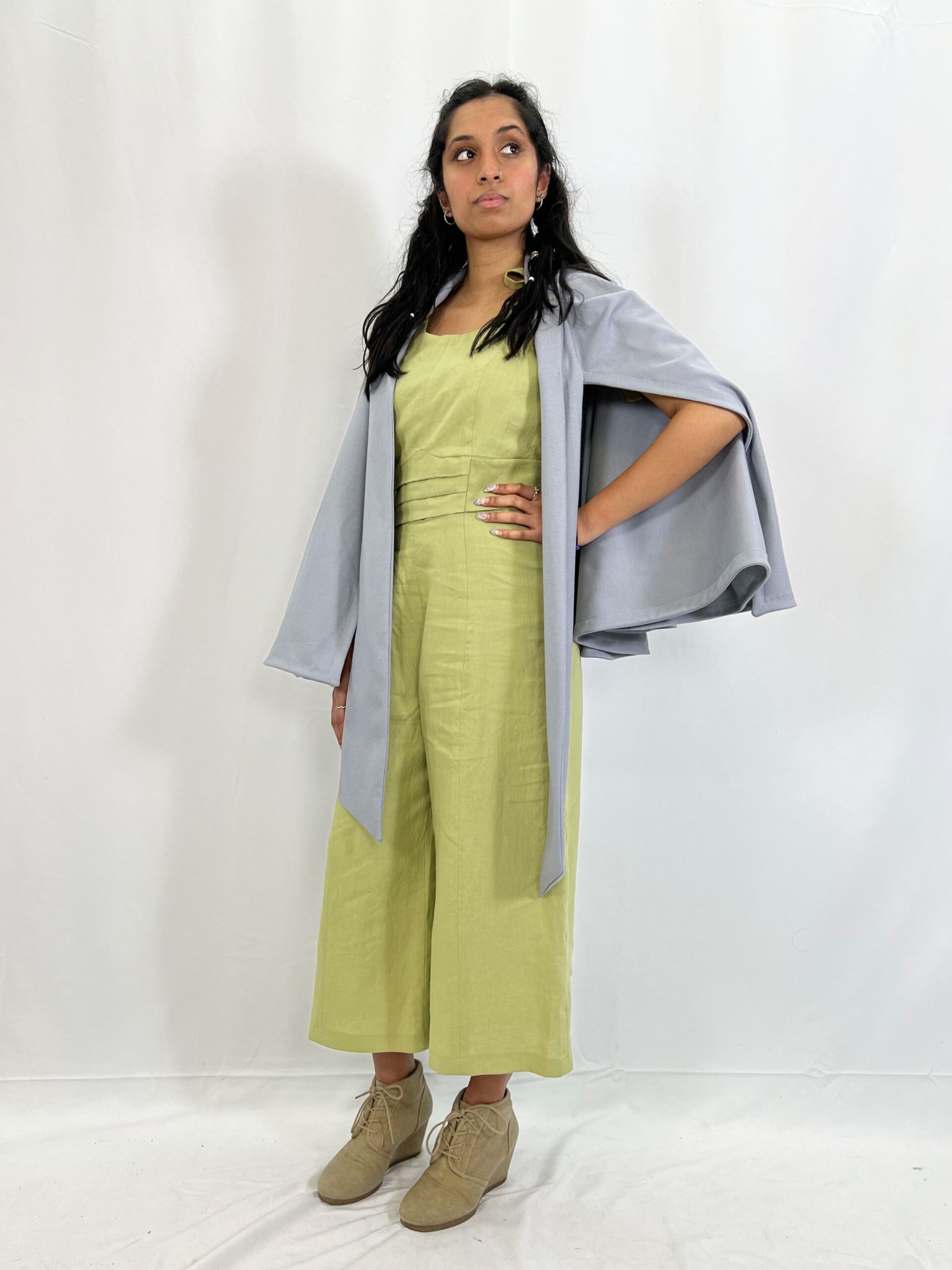 The Isabeau look includes a wool knit cape that can be worn in different ways, and a cotton jumpsuit with princess seams, welt pockets, and a pleated waistband that ties in the back. Modelled by Alana Naraine.